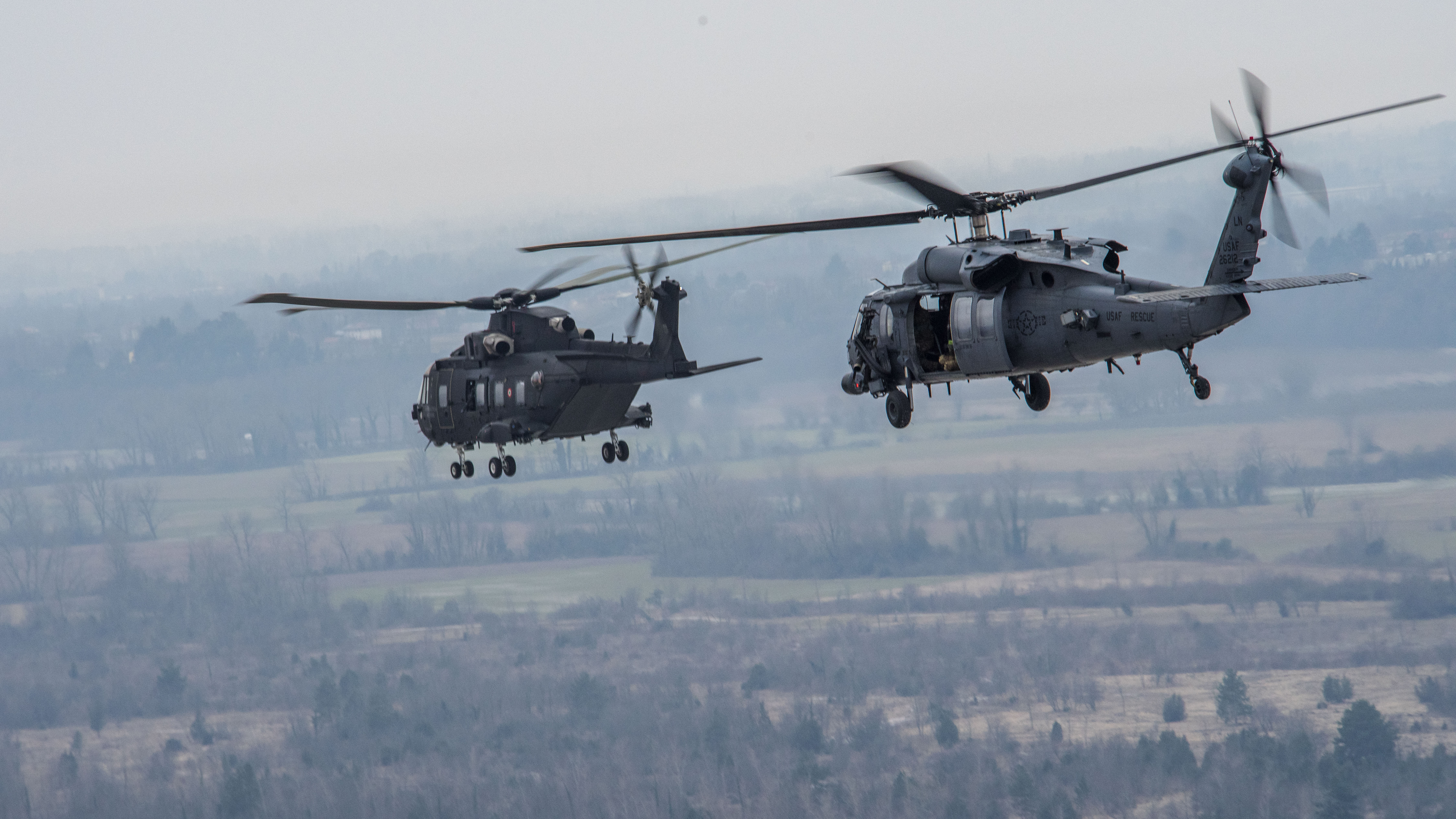 Two HH-60 helicopters flying